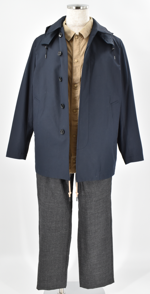 ネイビーのフードジャケットに、柔らかなベージュシャツとチャコールグレーのパンツを合わせた落ち着きのあるコーディネート。